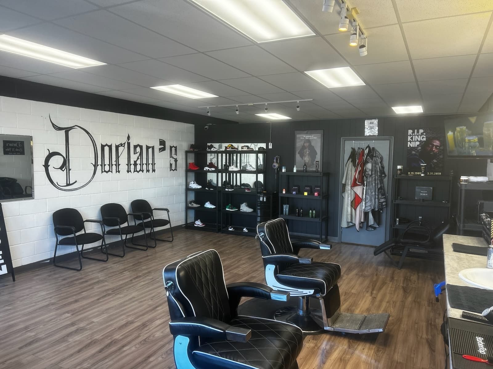 Inside Dorian's Braids & Fades - interior with wall sign